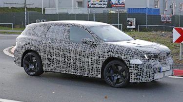 BMW iX3 M - front angled on a round-about