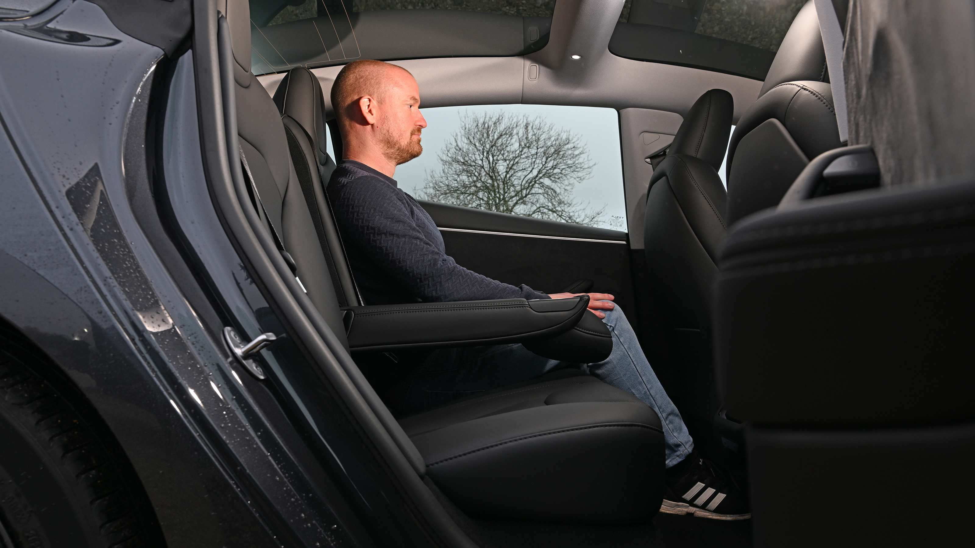 Auto Express chief reviewer Alex Ingram sitting in the Tesla Model 3's back seat