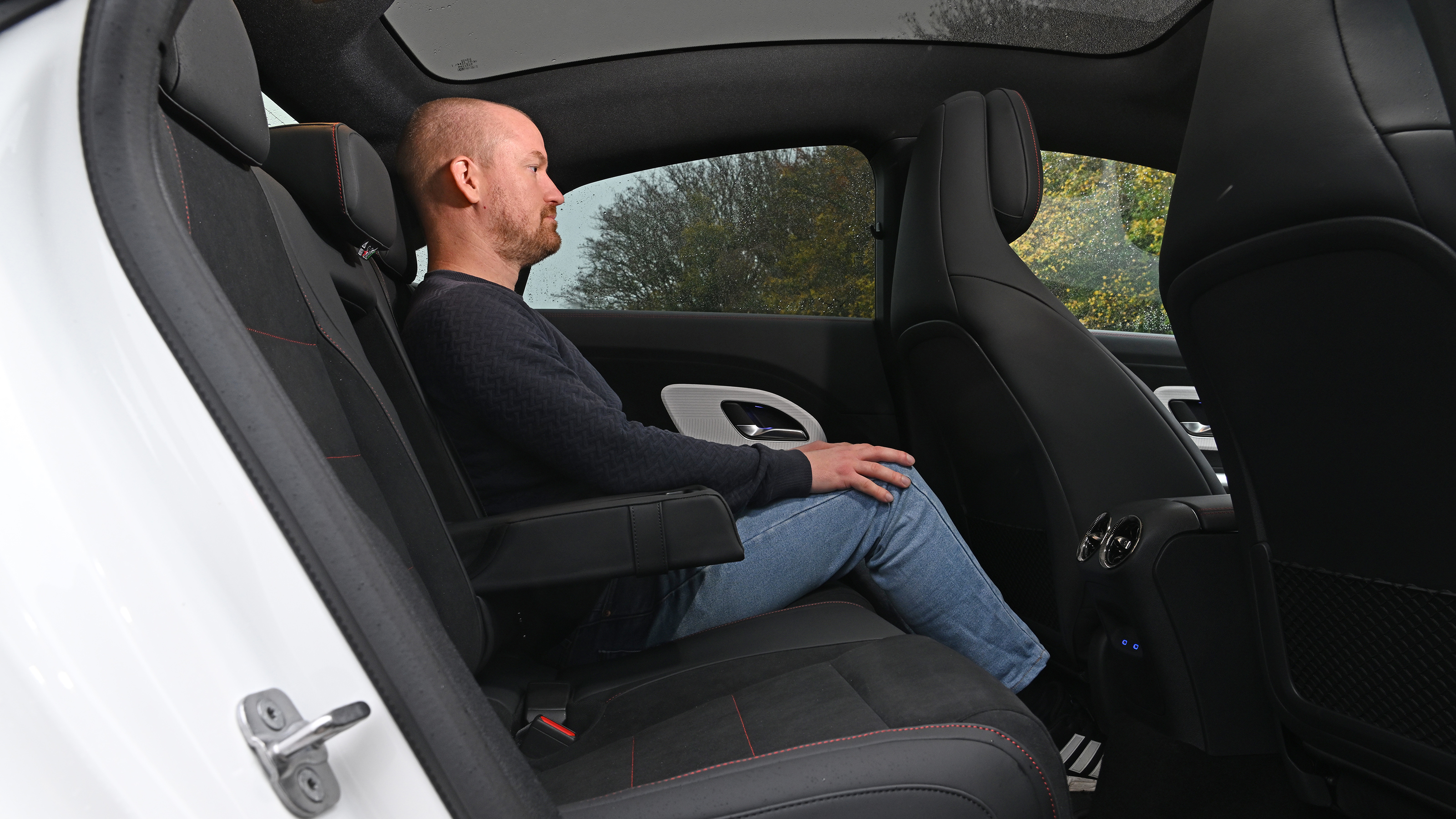 Auto Express chief reviewer Alex Ingram sitting in the Mercedes CLA's rear seat