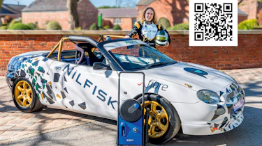 Eliza Seville standing next to an MG TF