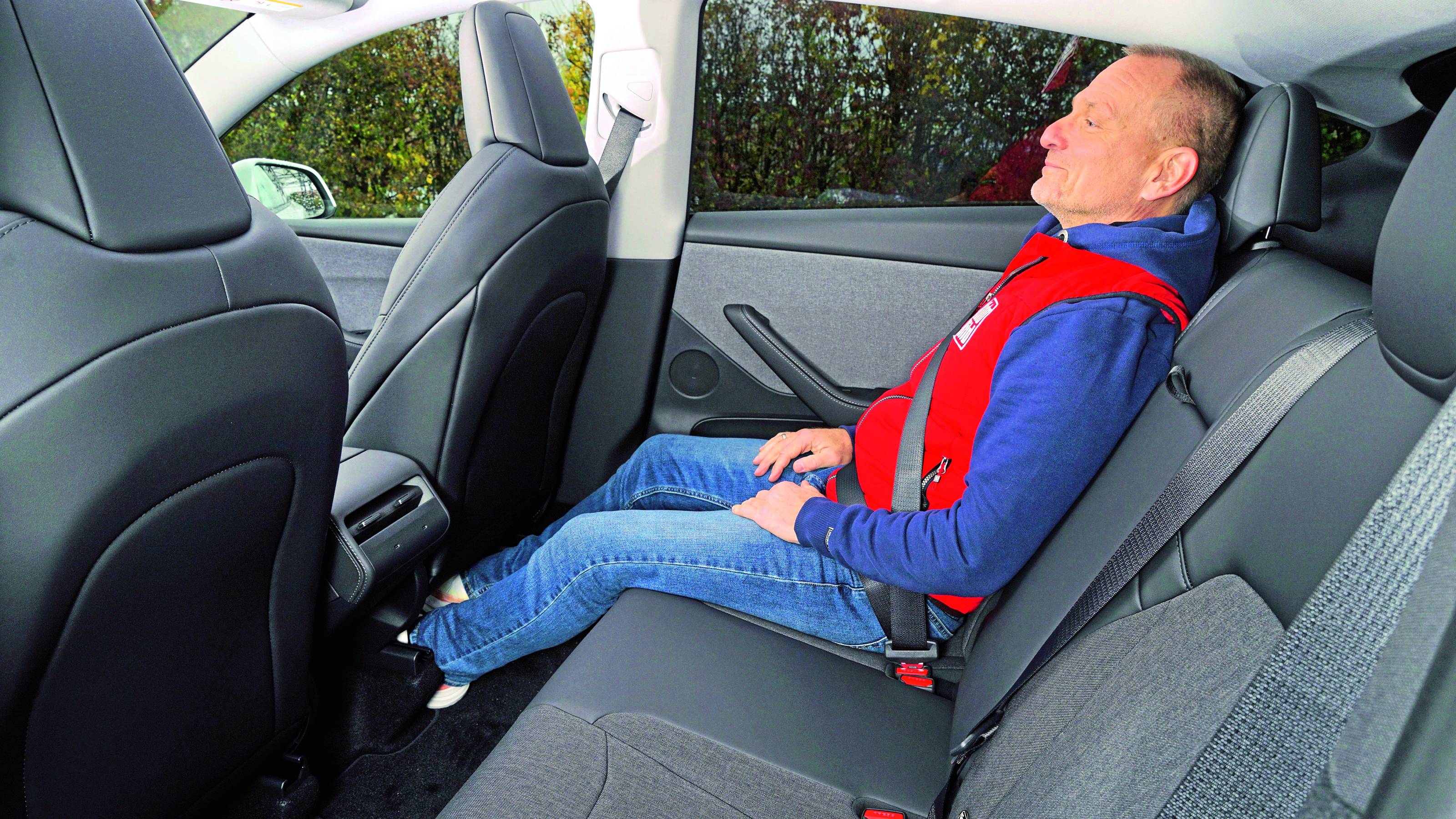 New Tesla Model Y Standard - rear seats being sat in by Holger Preiss from Auto Bild