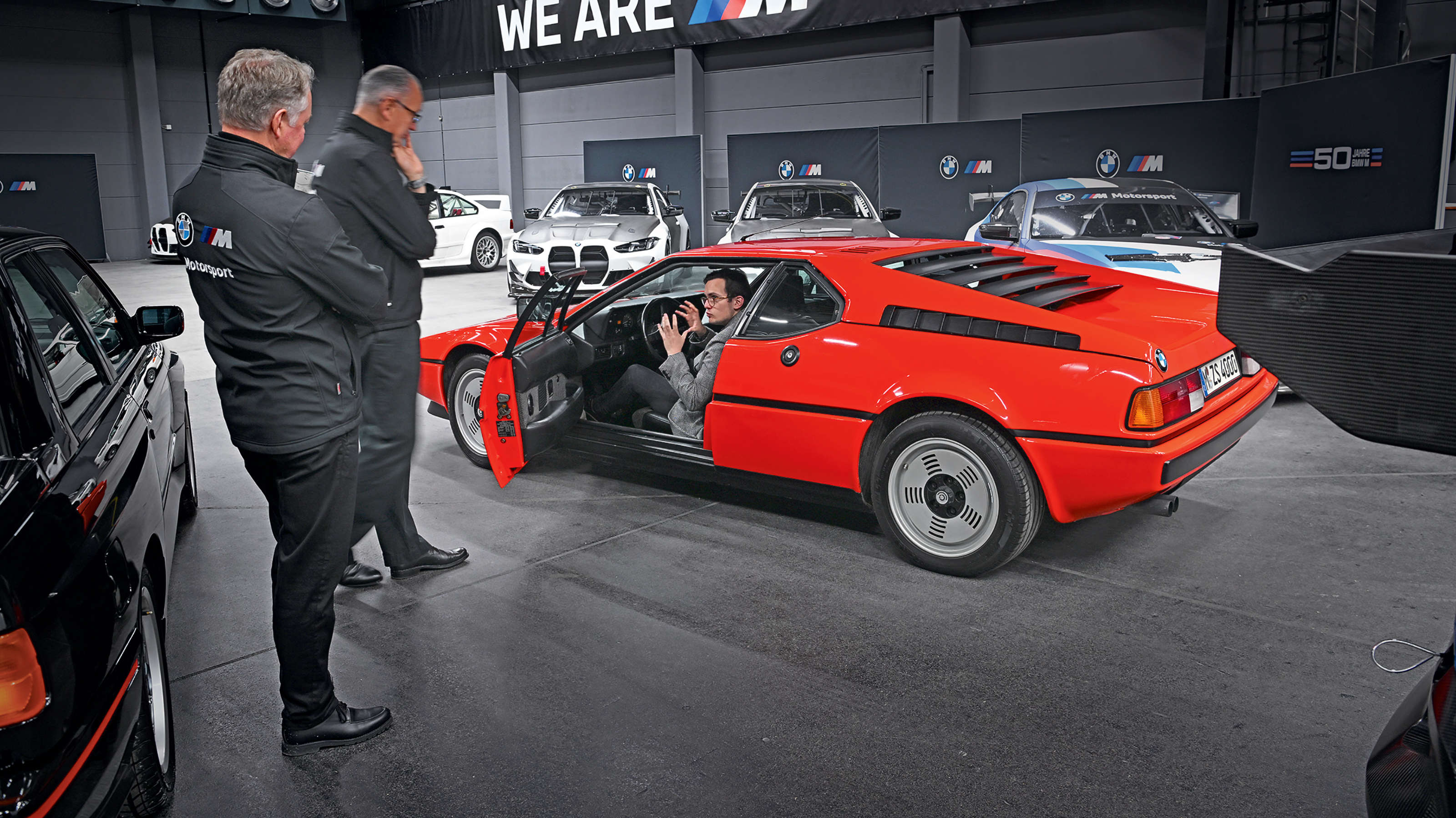 Auto Express consumer reporter Tom Jervis sitting in a BMW M1