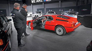 Auto Express consumer reporter Tom Jervis sitting in a BMW M1