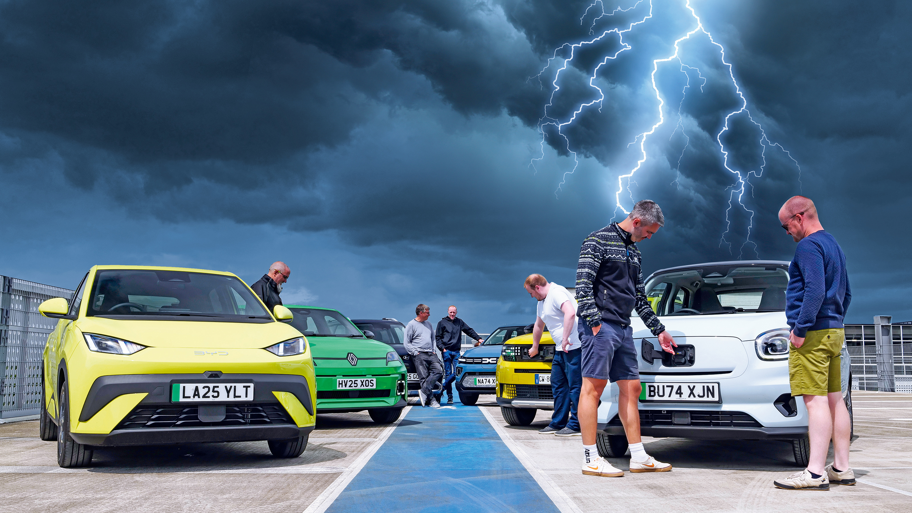 Auto Express team members standing with a selection of budget EVs