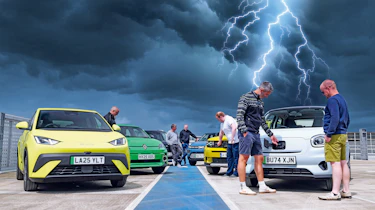 Auto Express team members standing with a selection of budget EVs