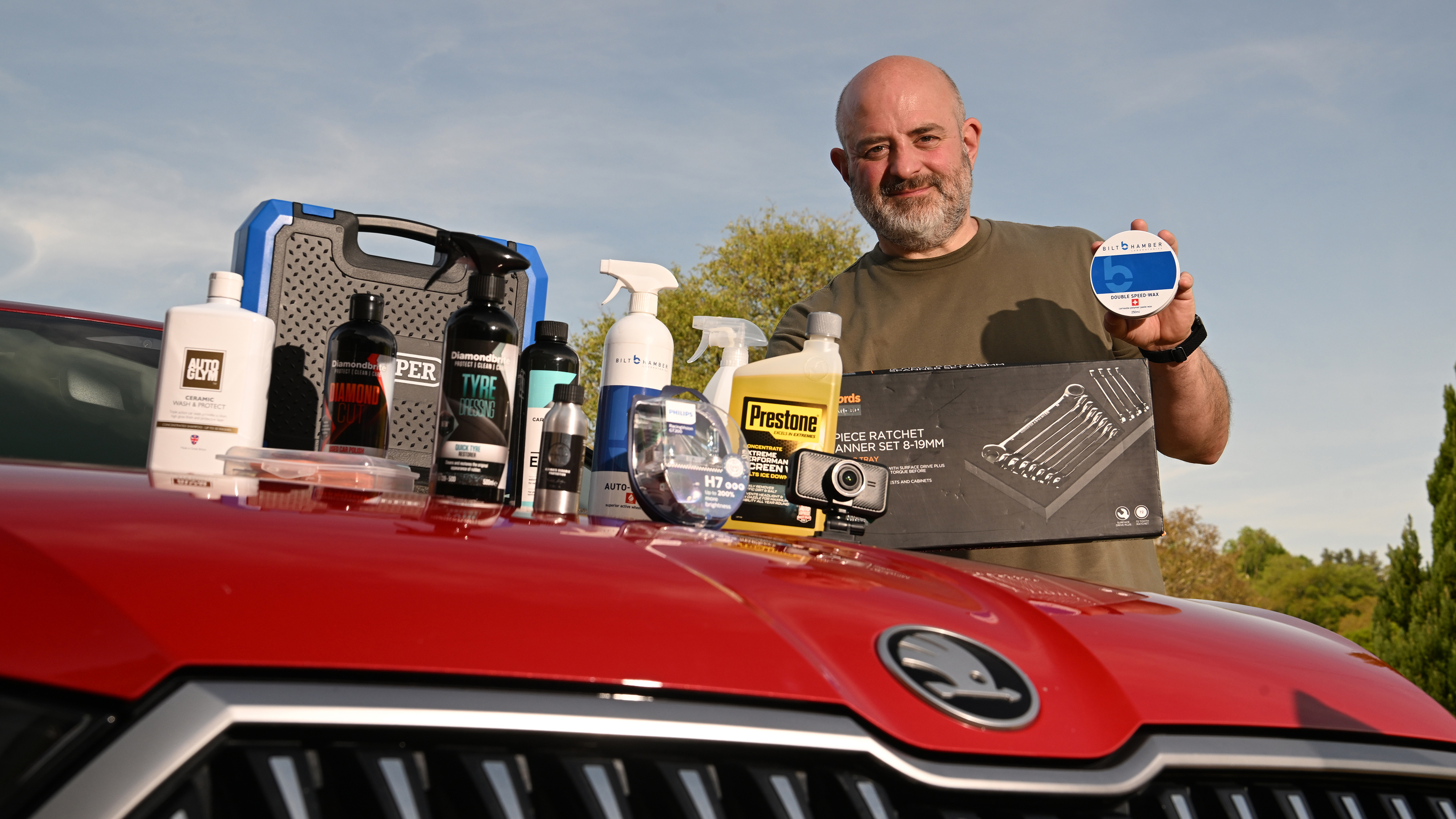 Auto Express products editor Tom Barnard standing next to a selection of car care products