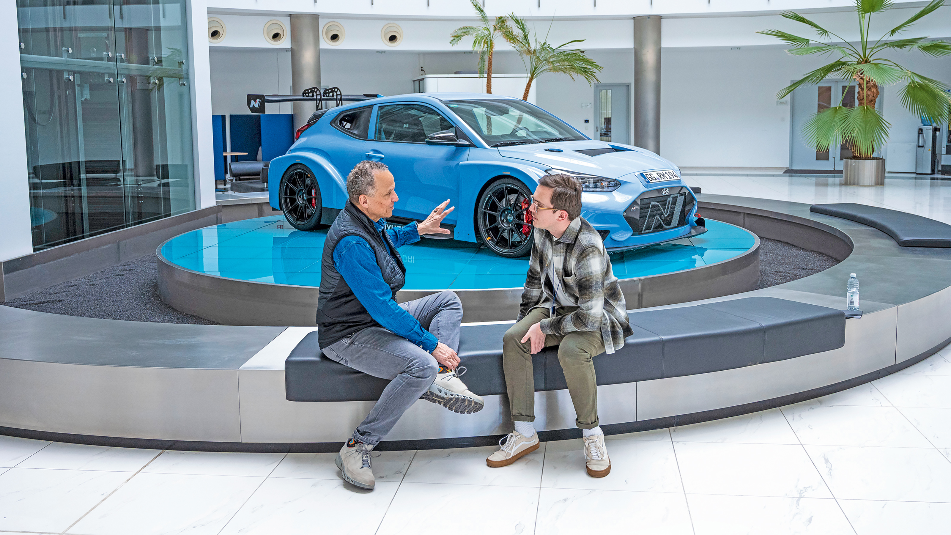 Auto Express consumer reporter Tom Jervis sitting in front of a Hyundai N car