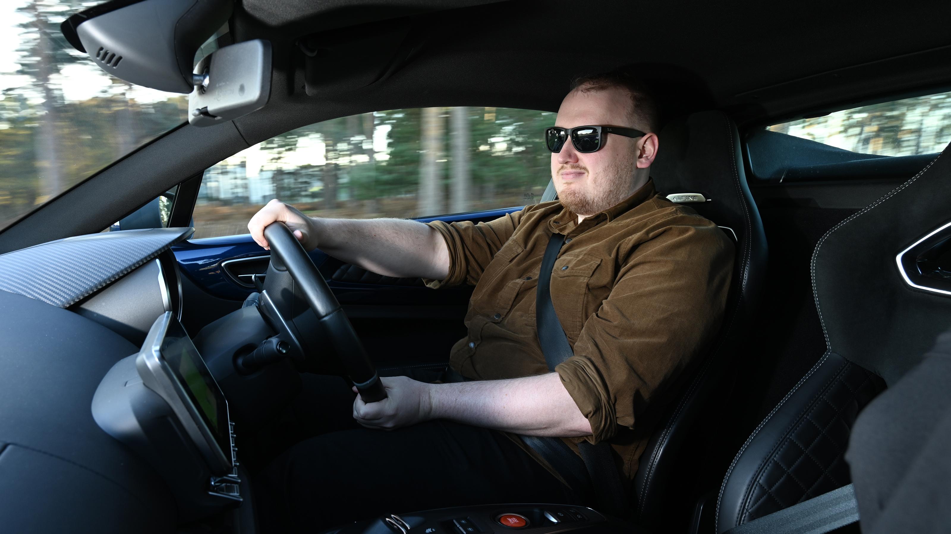 Auto Express news reporter Ellis Hyde driving an Alpine A110