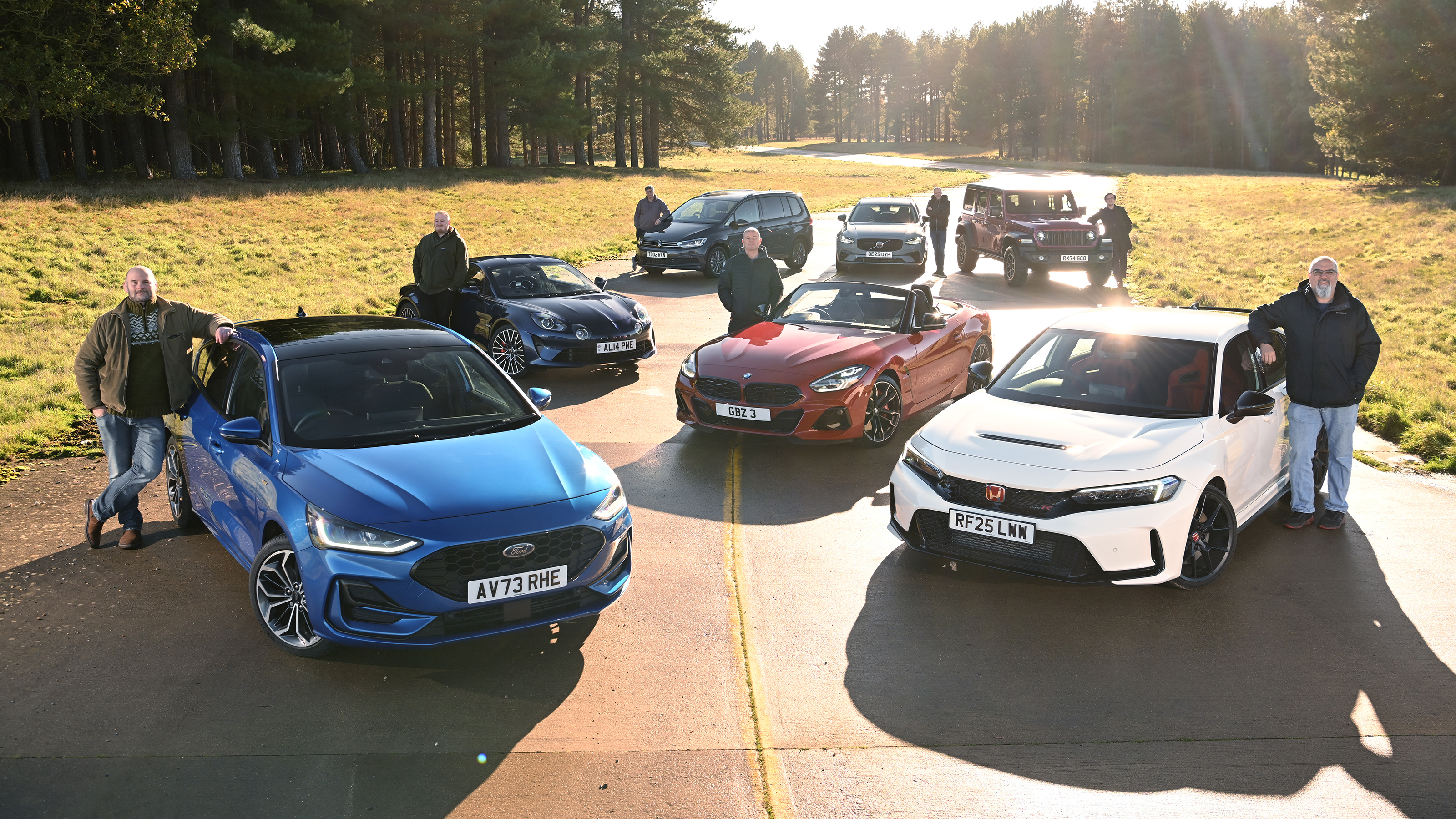 Auto Express team members standing with their favourite outgoing cars