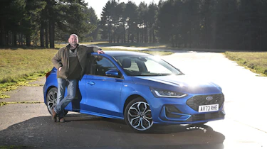 Cars to drive before they're gone feature - Darren Wilson standing next to a Ford Focus