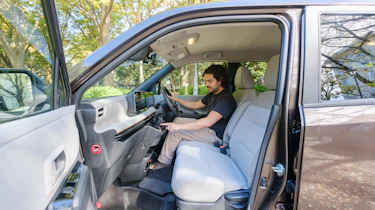Nissan Sakura - front interior, with Auto Express senior staff writer Jordan Katsianis sitting in the drivers seats