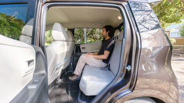 Nissan Sakura - rear interior being sat in by Auto Express senior staff writer Jordan Katsianis