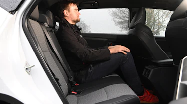 Alastair Crooks sitting in the Toyota bZ4X