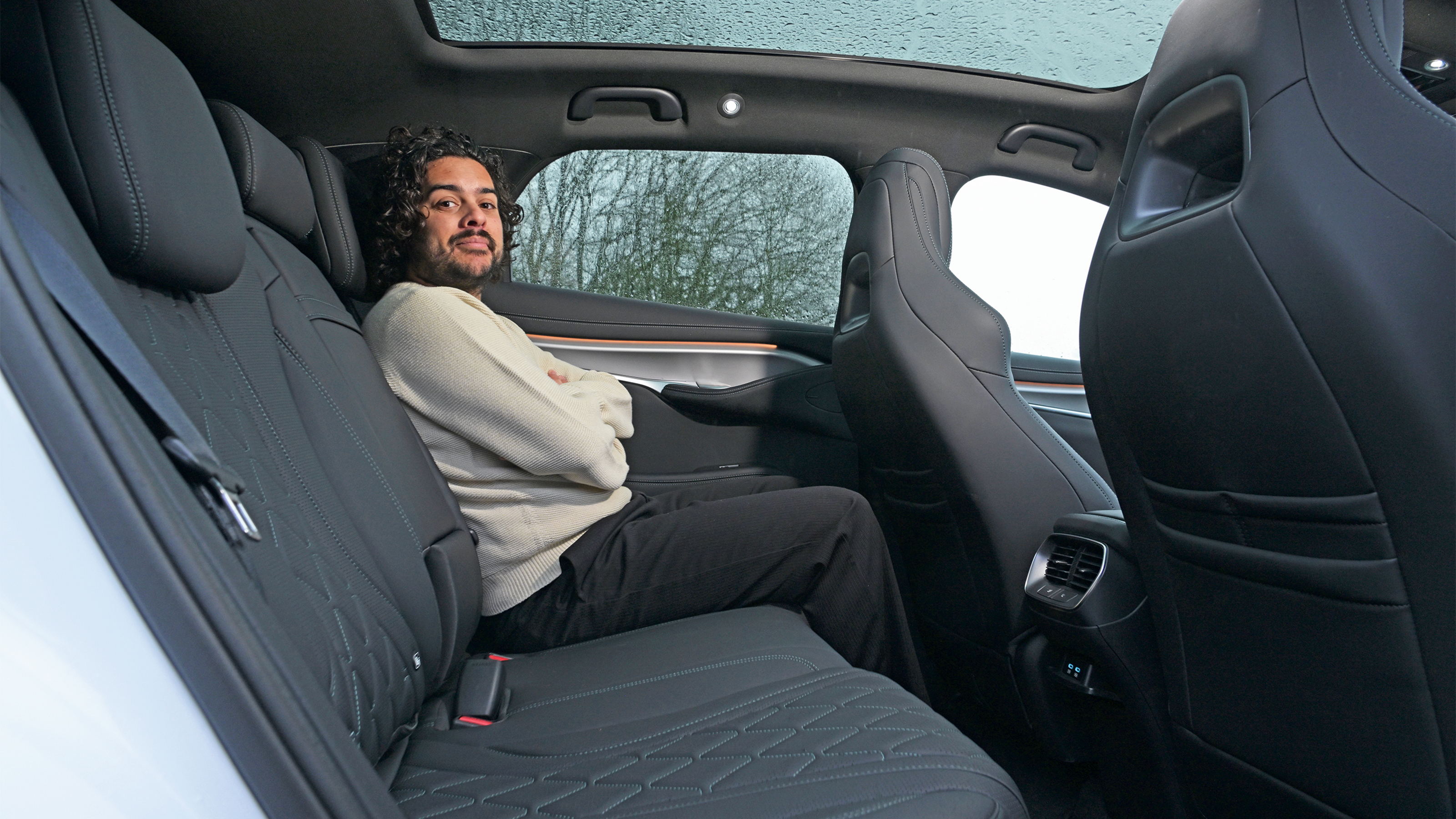 Auto Express news editor Jordan Katsianis sitting in the BYD Sealion 7's back seat