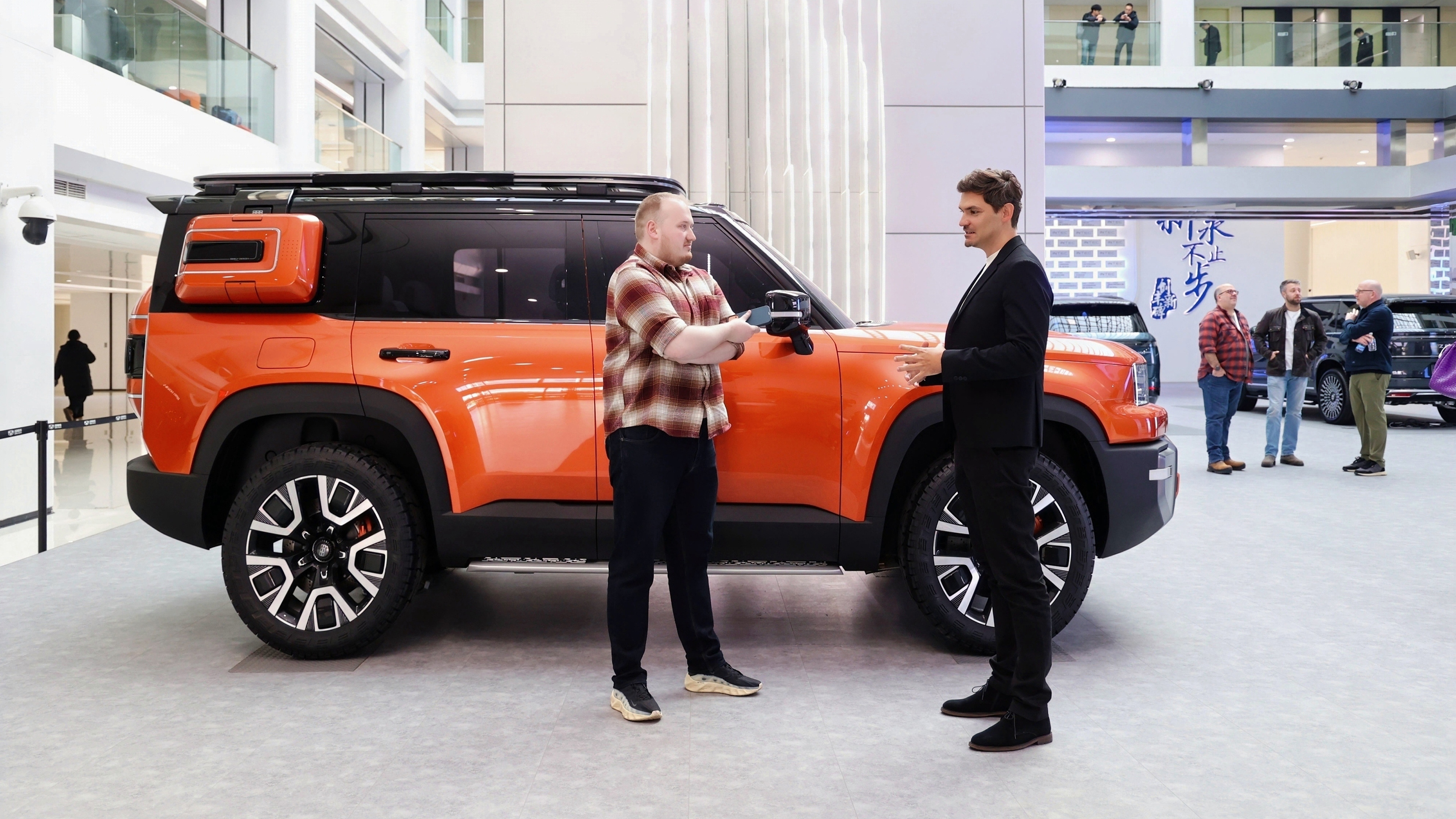 Auto Express news reporter Ellis Hyde and Flavien Dachet standing next to the Geely Galaxy Cruiser