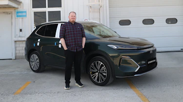 Auto Express news reporter Ellis Hyde standing in front of the Geely Starray EM-i