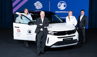 Team GB and Vauxhall representatives stood around a Vauxhall Frontera Electric