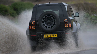 Land Rover Defender OCTA Black - rear cornering (wet)