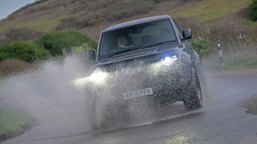 Land Rover Defender OCTA Black - front cornering (wet)