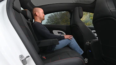 New Mercedes CLA being tested in the UK - rear interior, seat being sat in by Auto Express ex-chief reviewer Alex Ingram