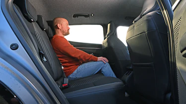 Former Auto Express chief reviewer Alex Ingram sitting in the Renault Megane E-Tech's rear seat