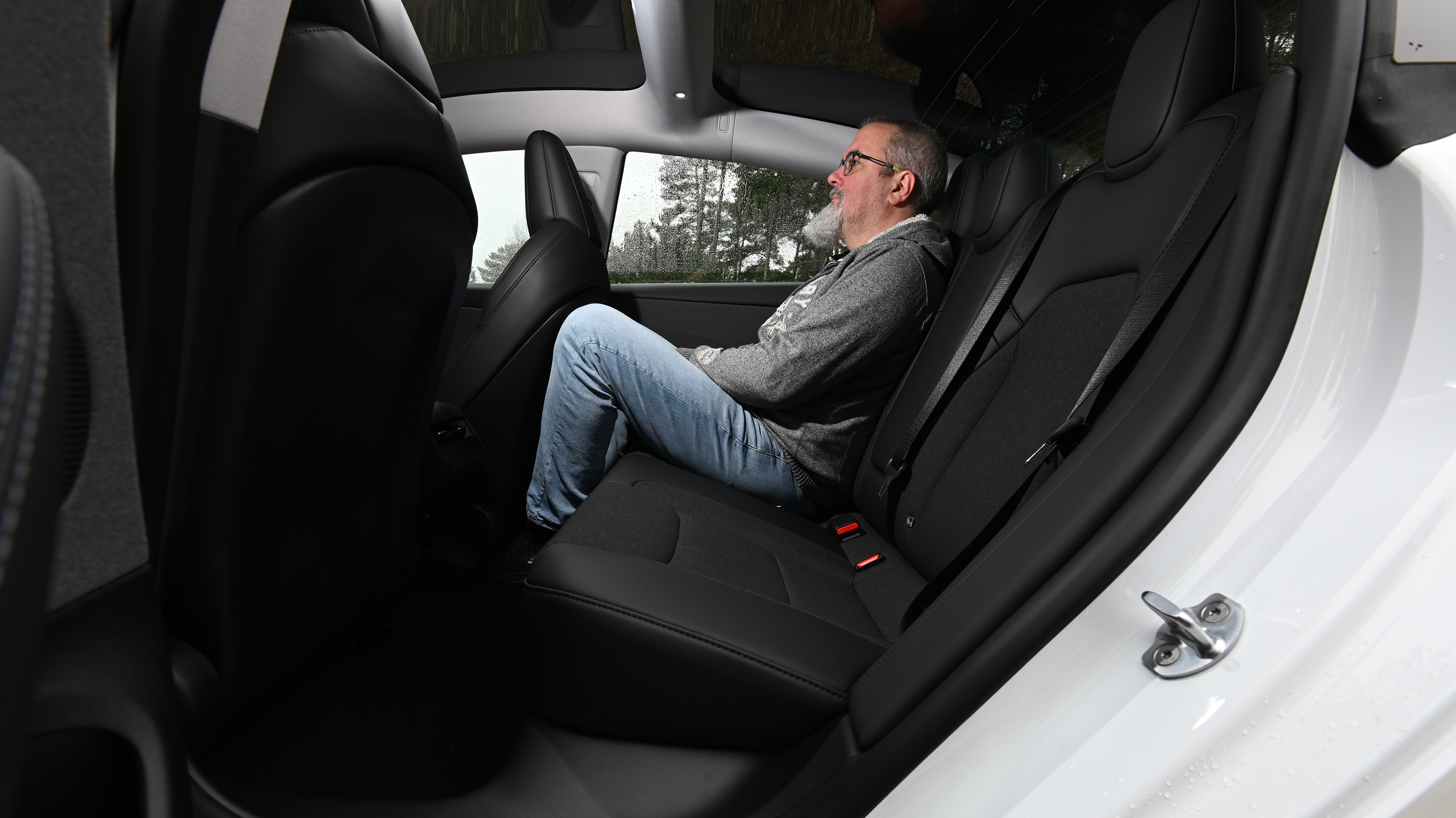 Auto Express senior test editor Dean Gibson sitting in the Tesla Model 3 RWD's rear seat