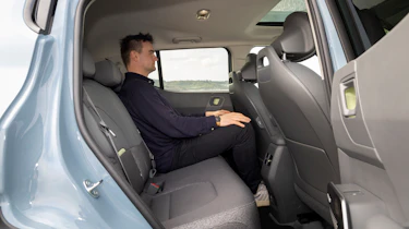 Alastair Crooks sat in the Kia EV2