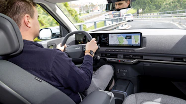 Alastair Crooks driving in the Kia EV2