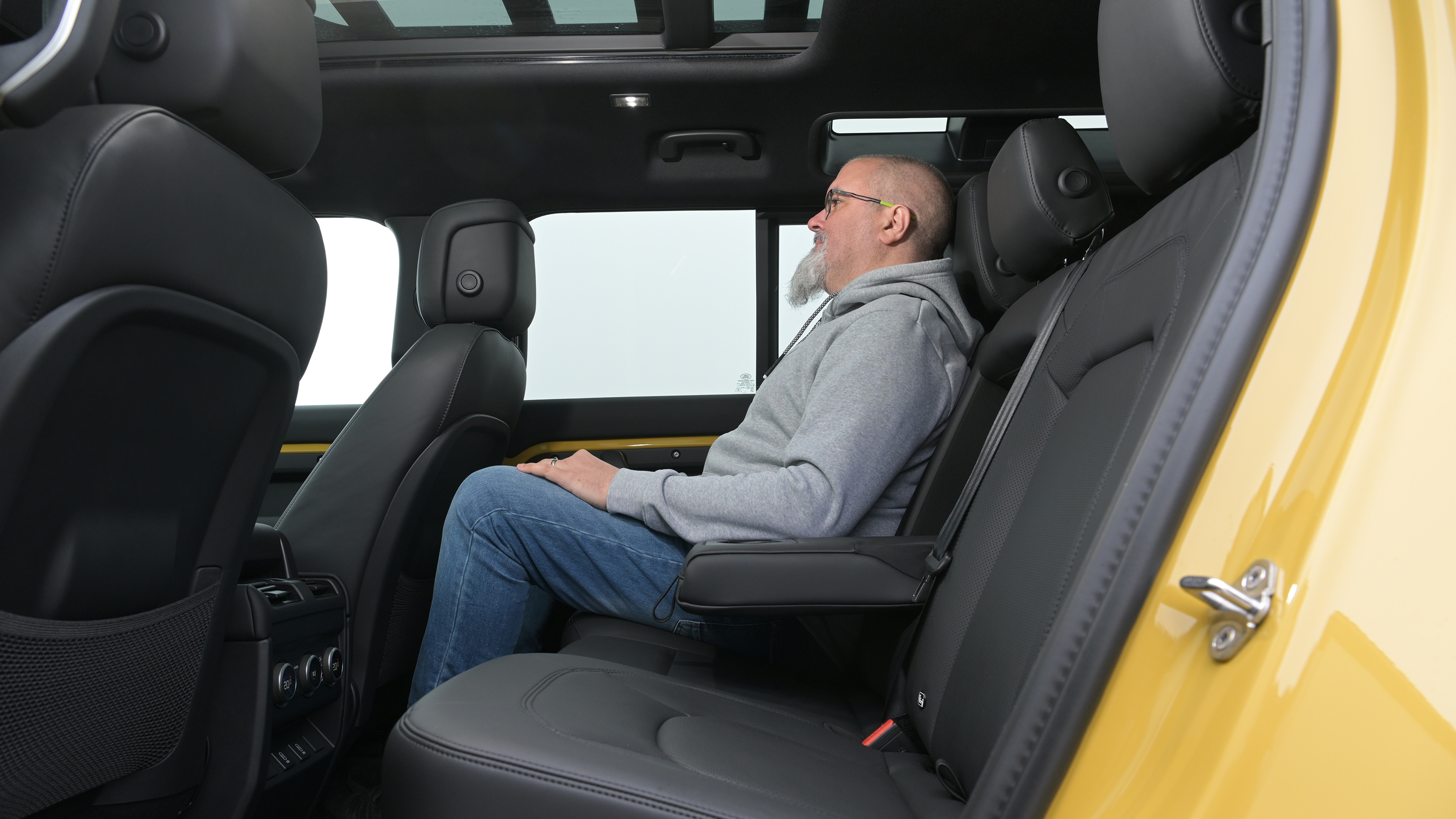 Auto Express senior test editor Dean Gibson sitting in the Land Rover Defender 110 Trophy Edition's rear seat