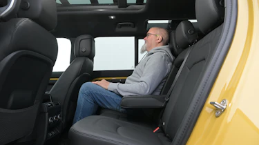 Auto Express senior test editor Dean Gibson sitting in the Land Rover Defender 110 Trophy Edition's rear seat