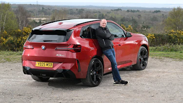 Auto Express Phil McNamara leaning against the BMW X3 30e xDrive M Sport