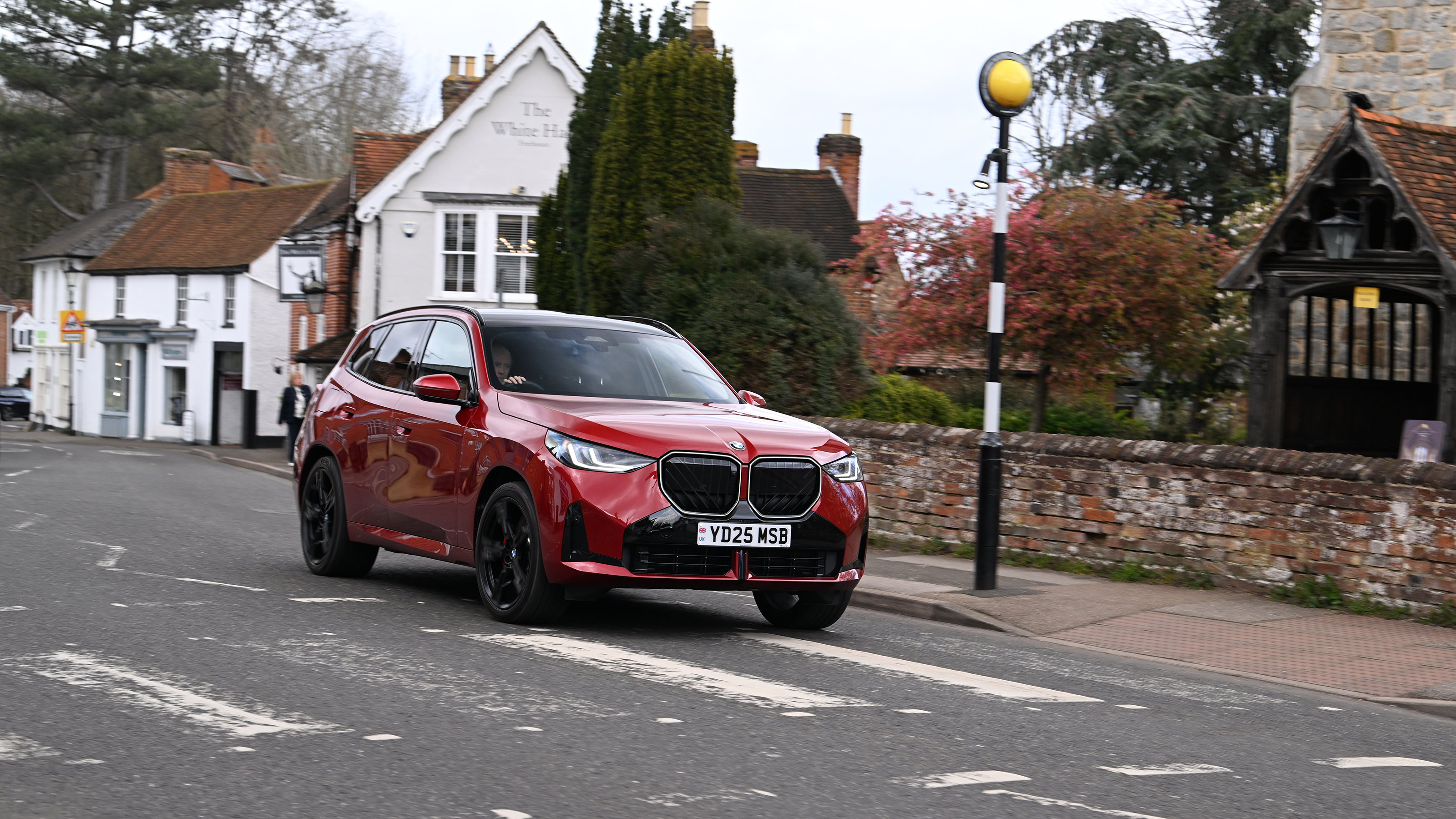 BMW X3 30e xDrive M Sport driving towards a Zebra crossing