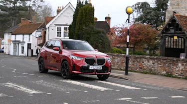BMW X3 30e xDrive M Sport driving towards a Zebra crossing