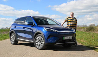 Auto Express news reporter Ellis Hyde standing next to the BYD Atto 3 EVO