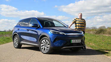 Auto Express news reporter Ellis Hyde standing next to the BYD Atto 3 EVO