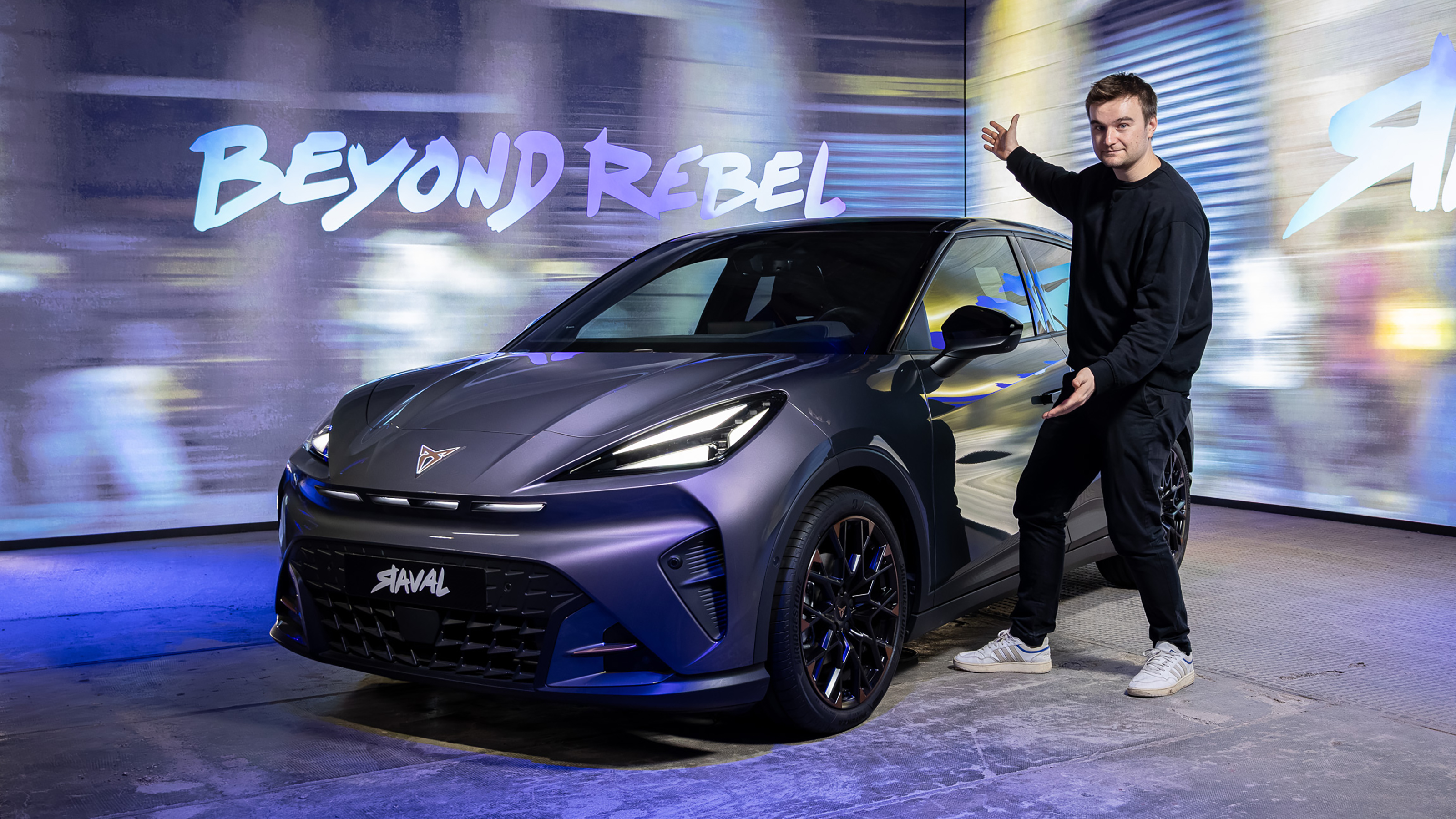 Auto Express senior news reporter Alastair Crooks standing next to a Cupra Raval