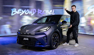 Auto Express senior news reporter Alastair Crooks standing next to a Cupra Raval