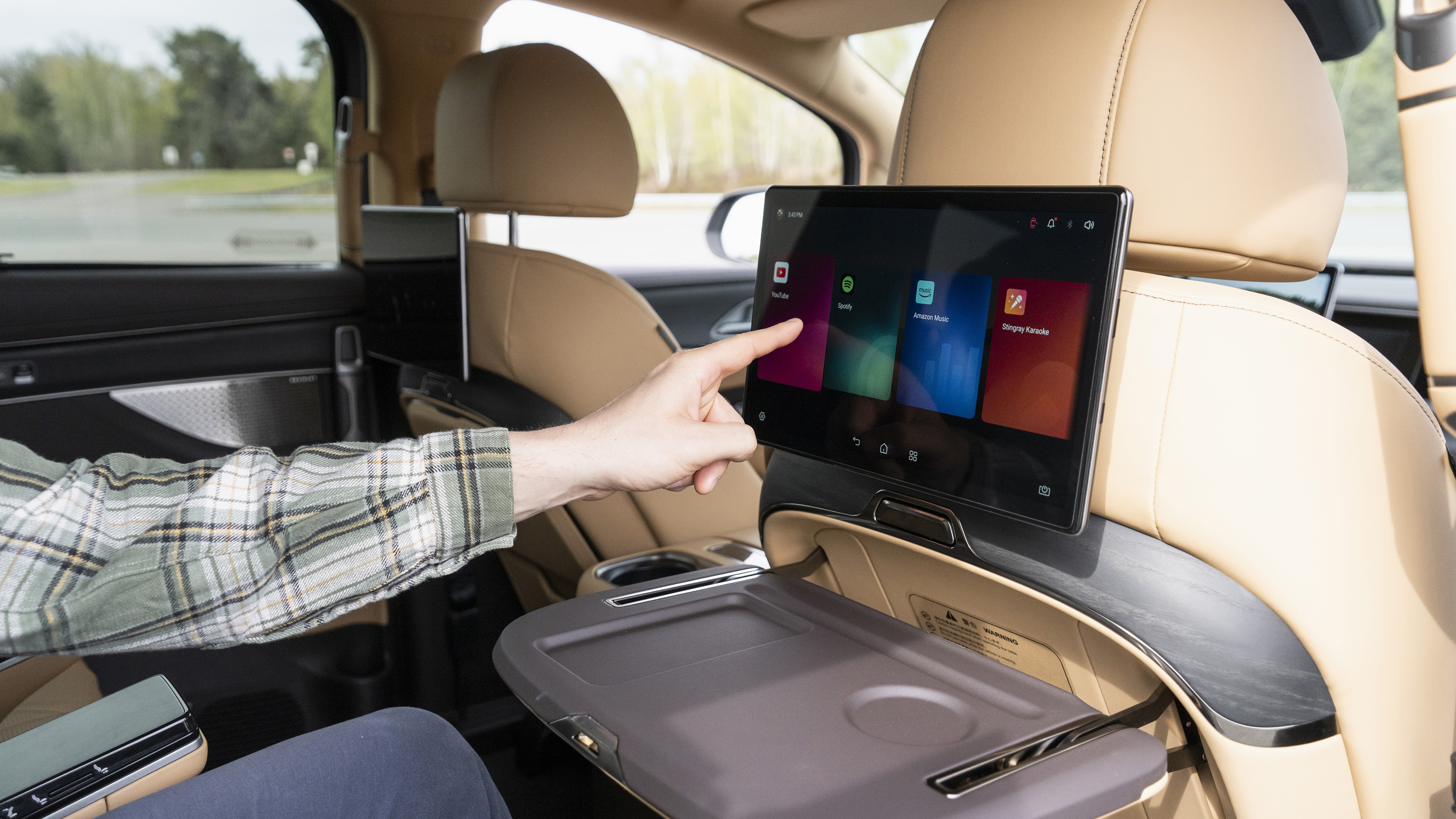 New Denza D9 - Auto Express senior news reporter Alastair Crooks using the rear infotainment screen