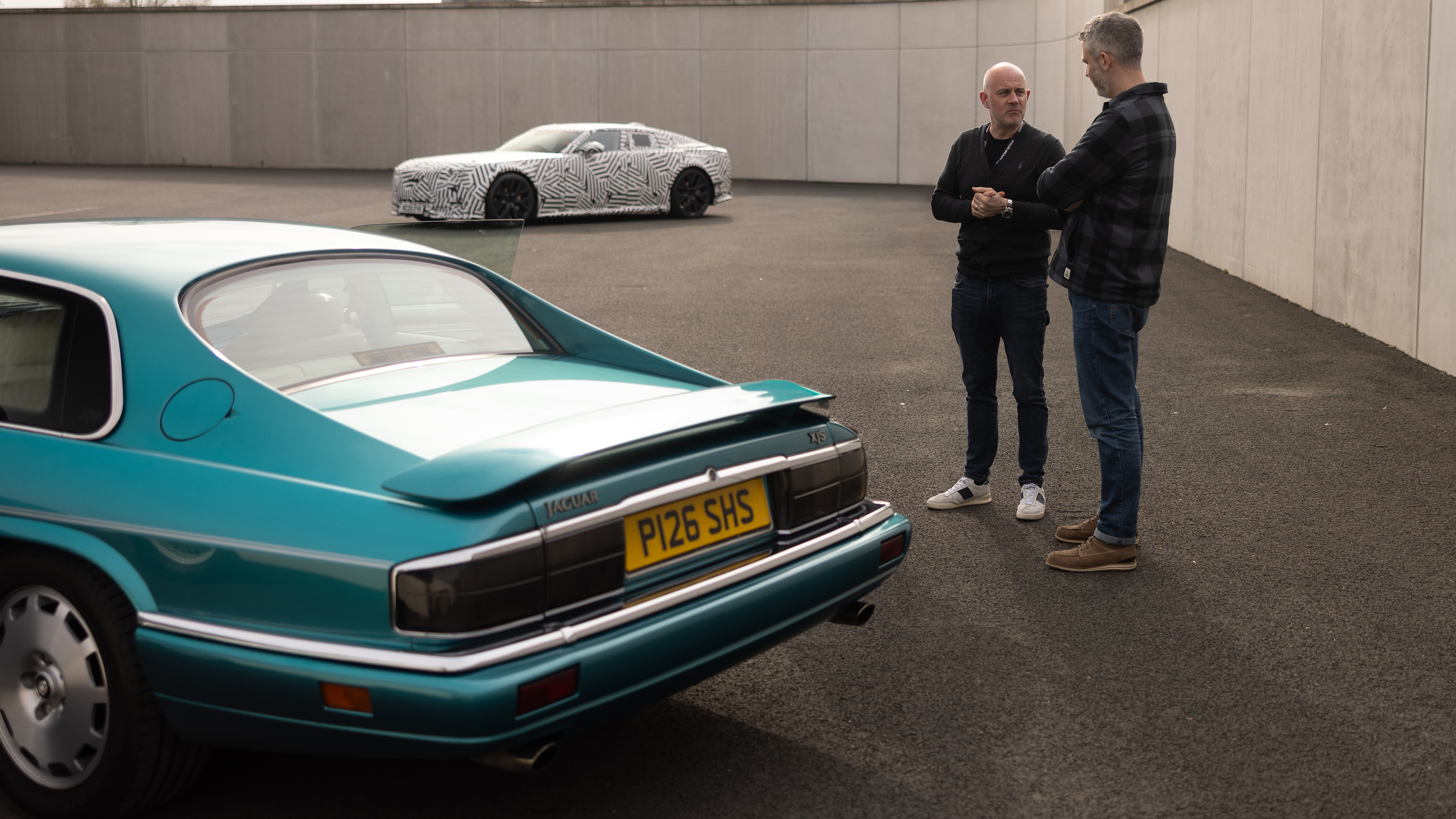 Jaguar cars which helped build the GT - rear of Jaguar XJS with Auto Express deputy editor Richard Ingram talking to Jon Darlington cheif engineer 