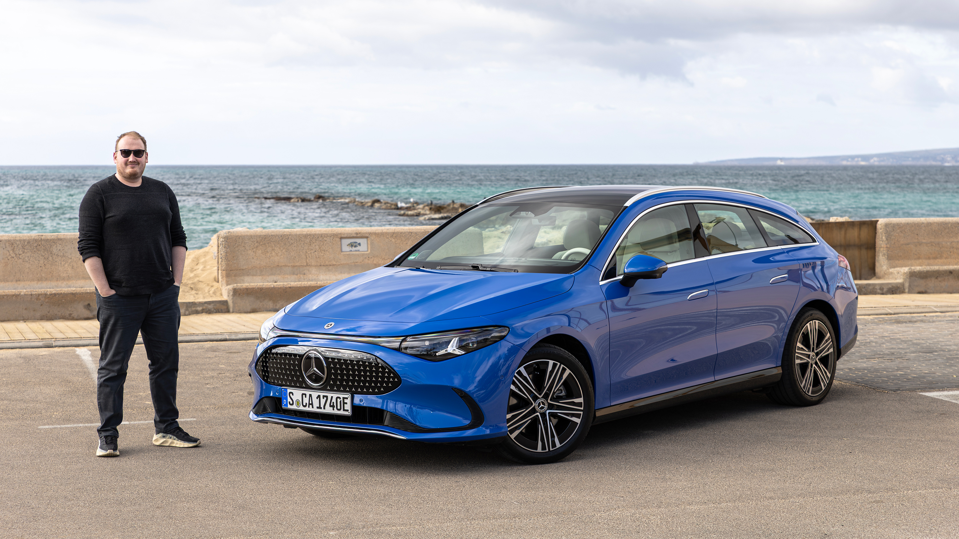 Auto Express news reporter Ellis Hyde standing next to the Mercedes CLA Shooting Brake
