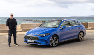 Auto Express news reporter Ellis Hyde standing next to the Mercedes CLA Shooting Brake