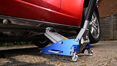 Auto Express Product Awards 2026 - products editor Tom Barnard jacking his car up using the Clarke Racing 1.5 tonne trolley jack