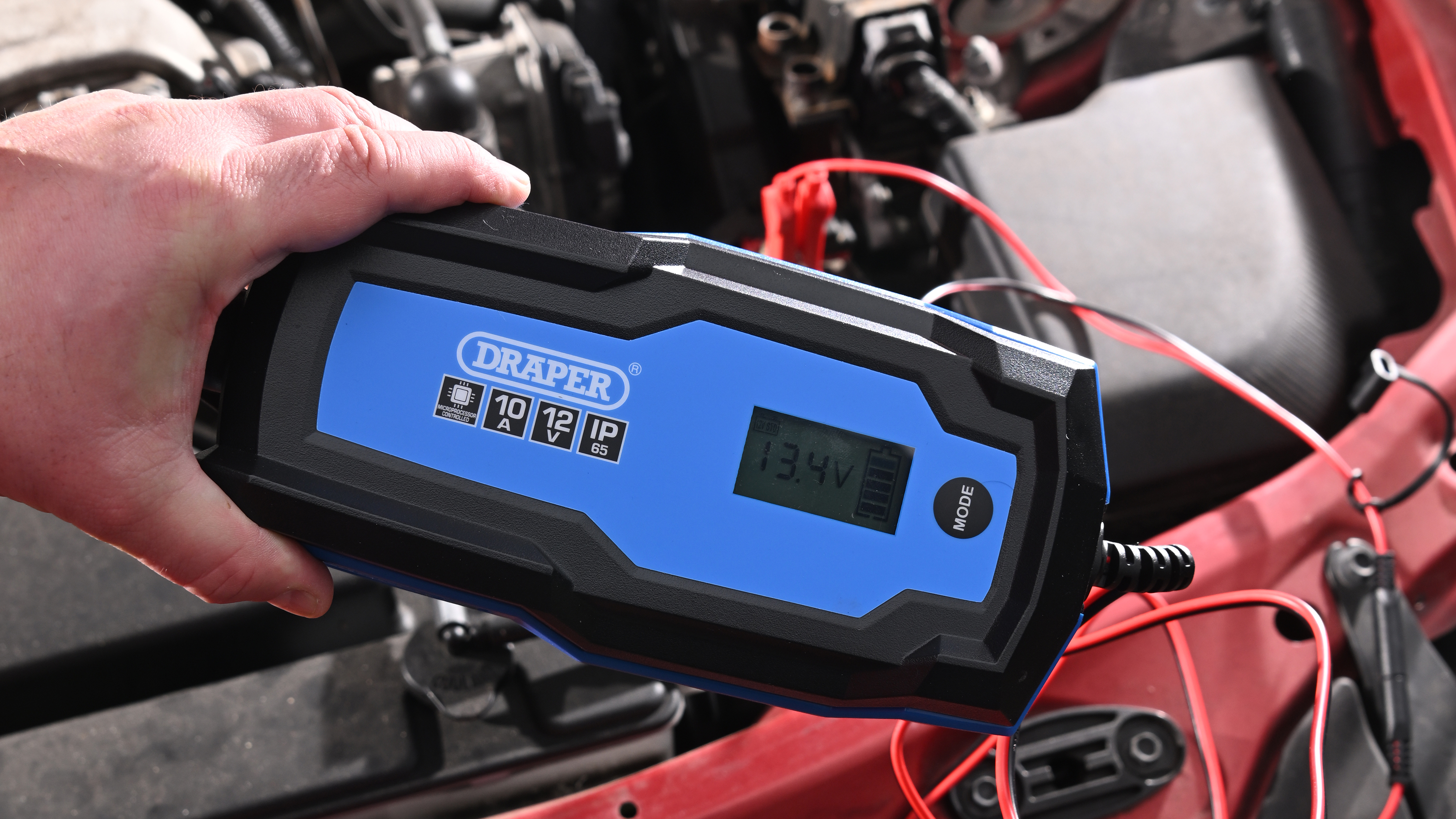 Auto Express Product Awards 2026 - products editor Tom Barnard using the Draper 12V battery charger