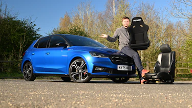 Skoda Fabia 130 long-term test - Senior news reporter Alastair Crooks sat on the bonnet of the Skoda holding a racing car seat