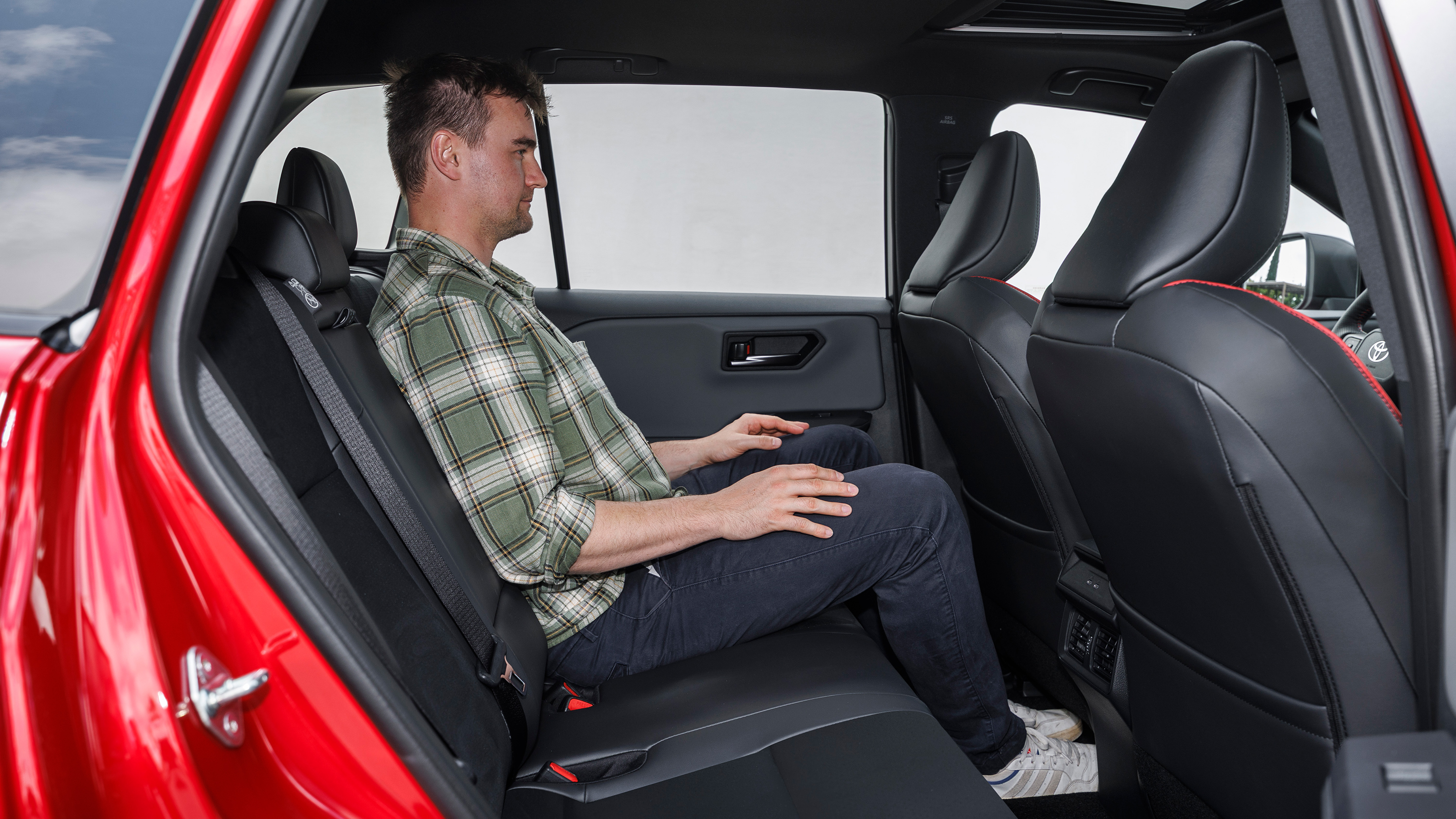 Auto Express senior news reporter Alastair Crooks sitting in the Toyota RAV4's rear seat