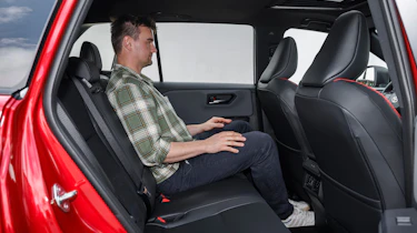 Auto Express senior news reporter Alastair Crooks sitting in the Toyota RAV4's rear seat