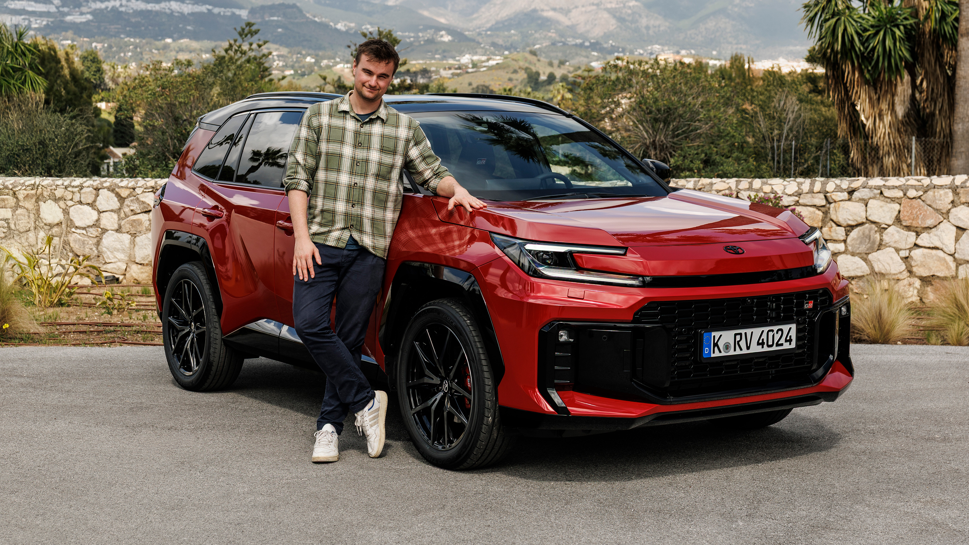Auto Express senior news reporter Alastair Crooks standing next to the Toyota RAV4