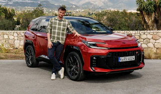 Auto Express senior news reporter Alastair Crooks standing next to the Toyota RAV4