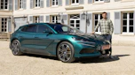 Auto Express senior news reporter Alastair Crooks standing next to the Denza Z9GT EV