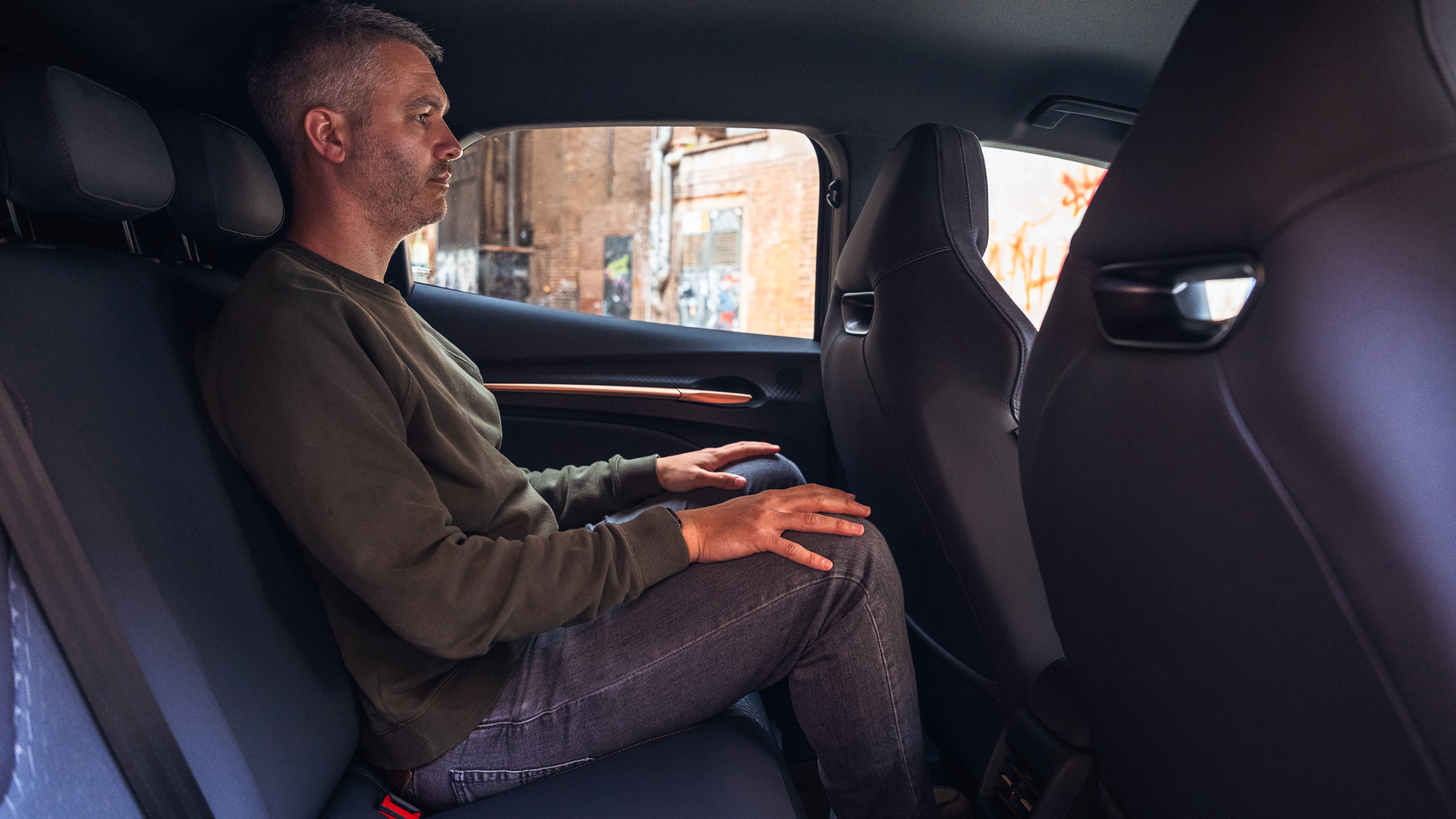Auto Express deputy editor Richard Ingram sitting in the Cupra Raval's rear seat